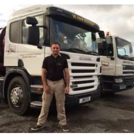 <img src="tanker.jpg" alt="Man standing in front of a maroon and white septic tank emptying tanker">